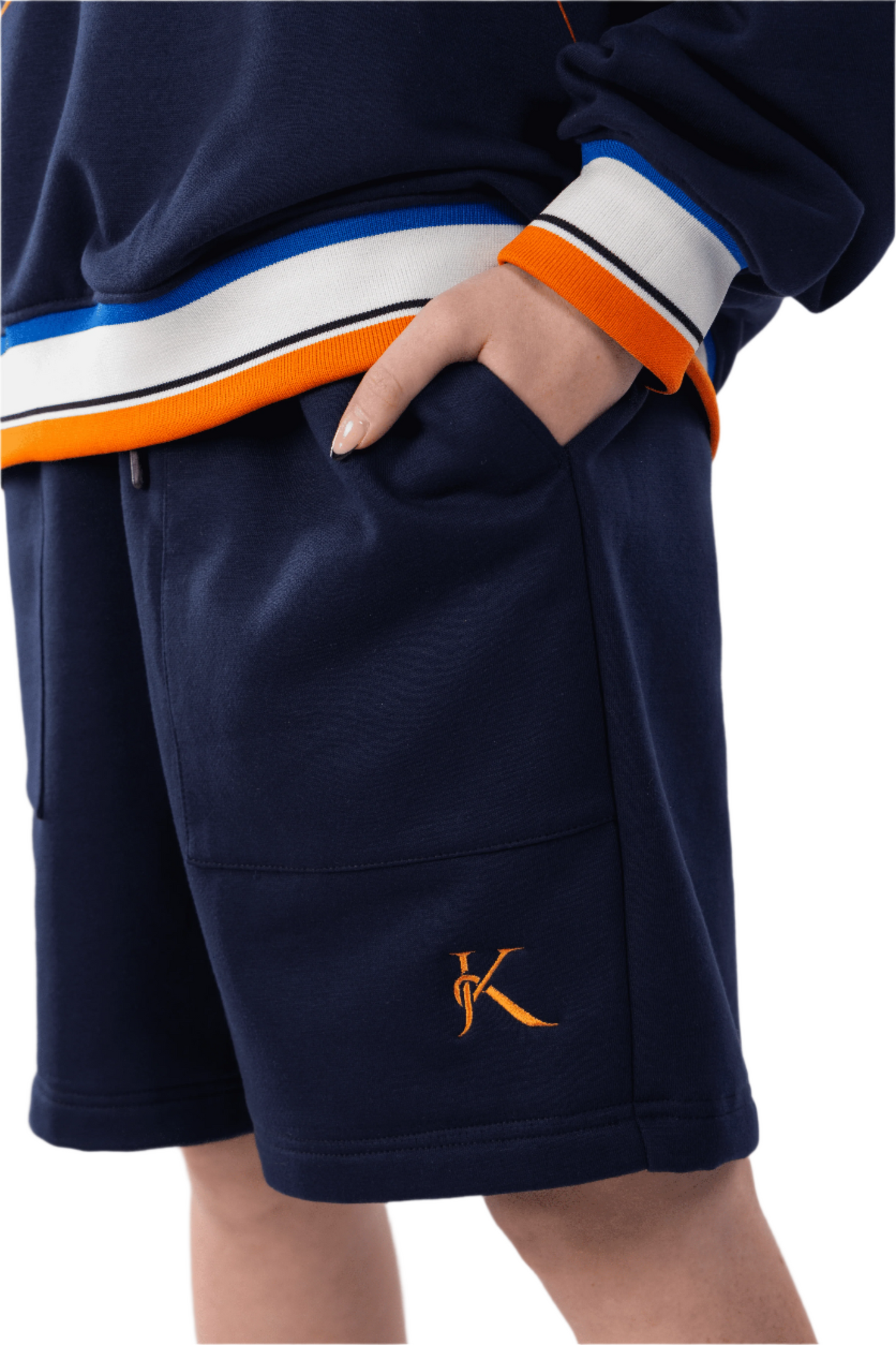 Navy shorts with orange and white trim on a plain background