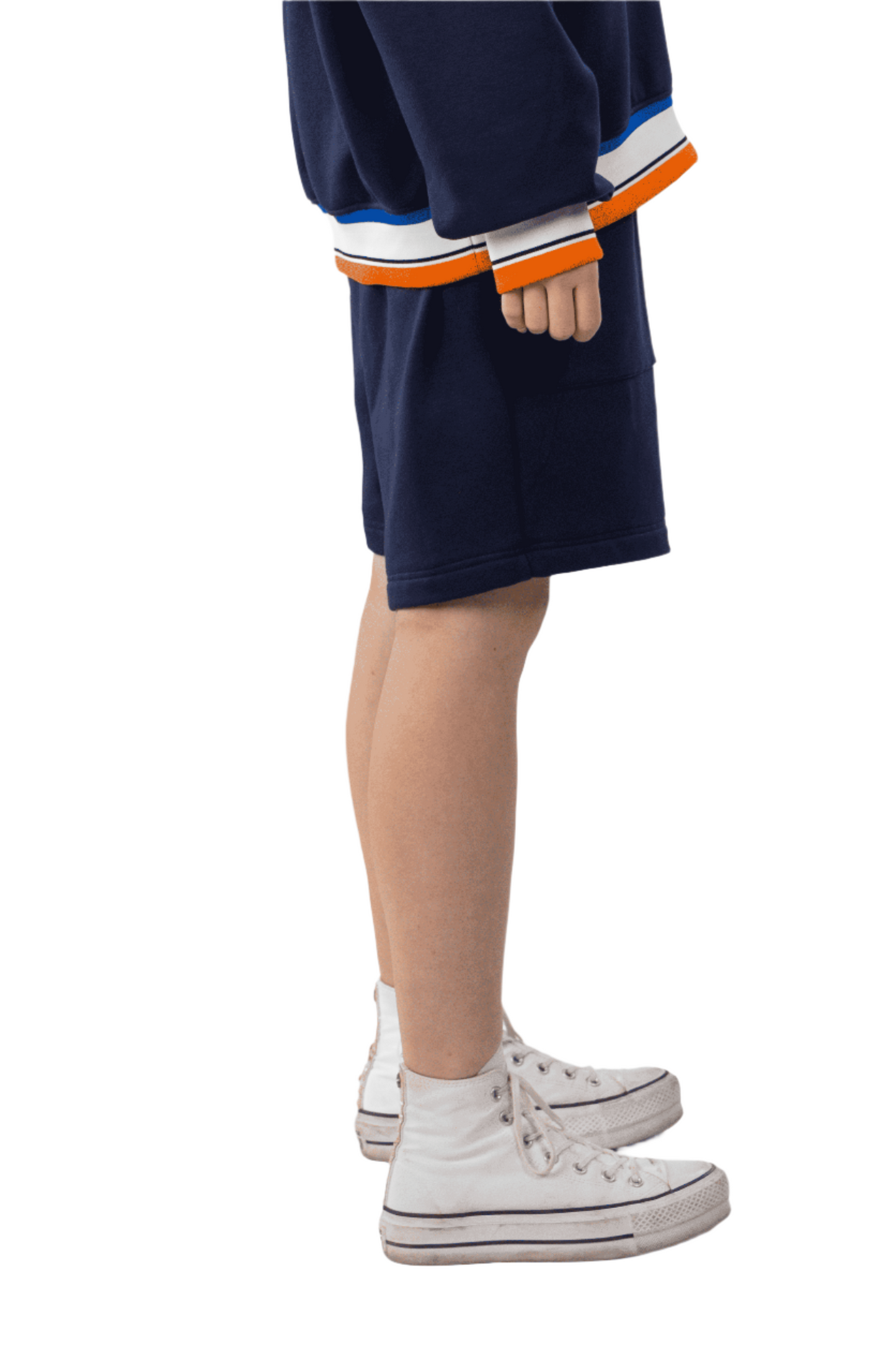 Person wearing a navy blue outfit with orange and white accents on a white background