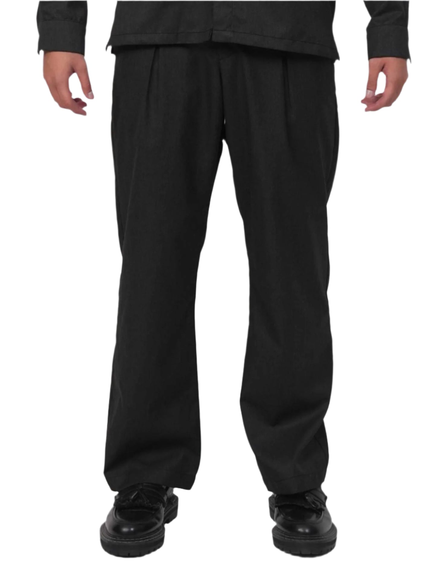 Person wearing a black outfit with a brand logo on a white background