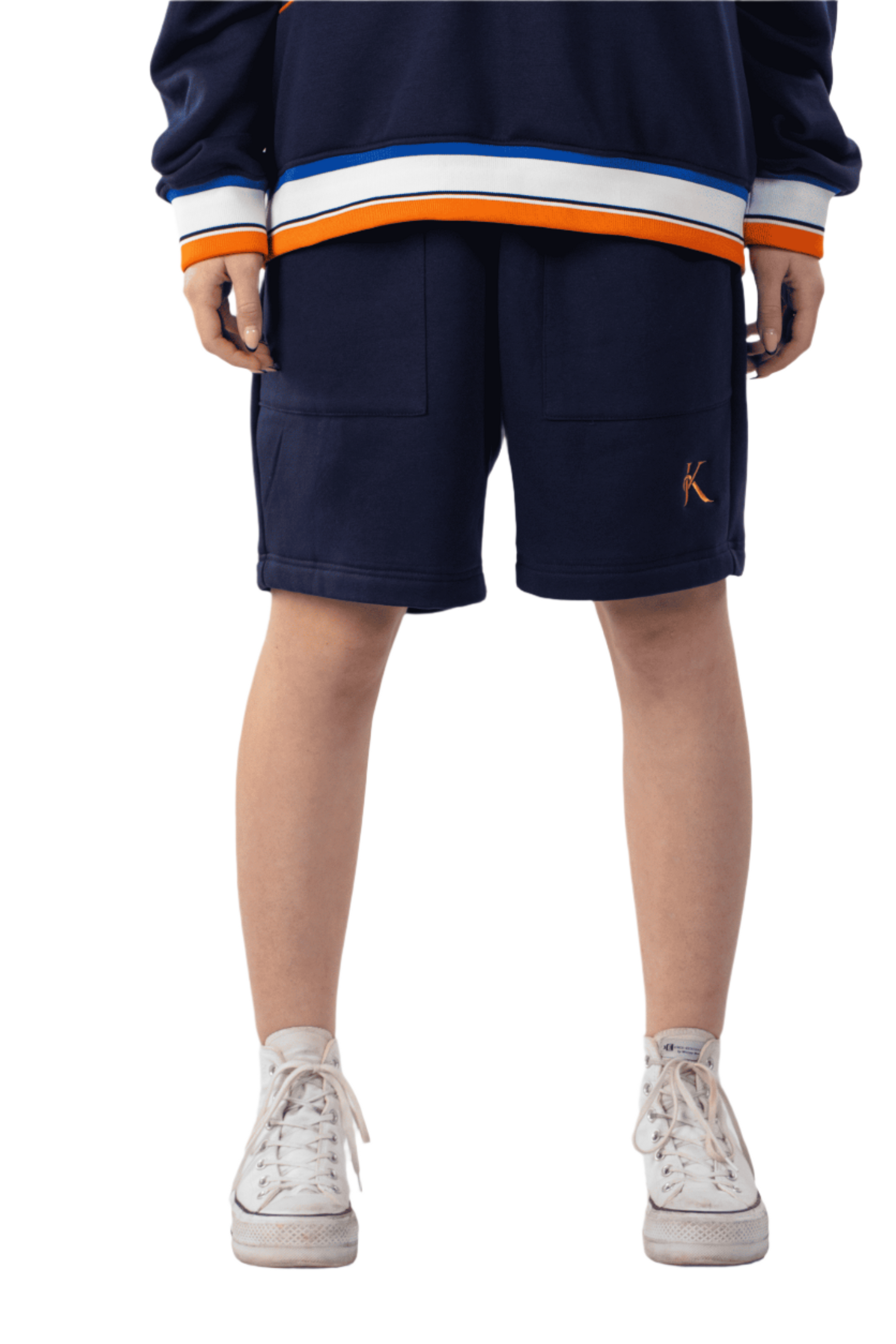 Person wearing a navy blue outfit with orange and white accents on a white background